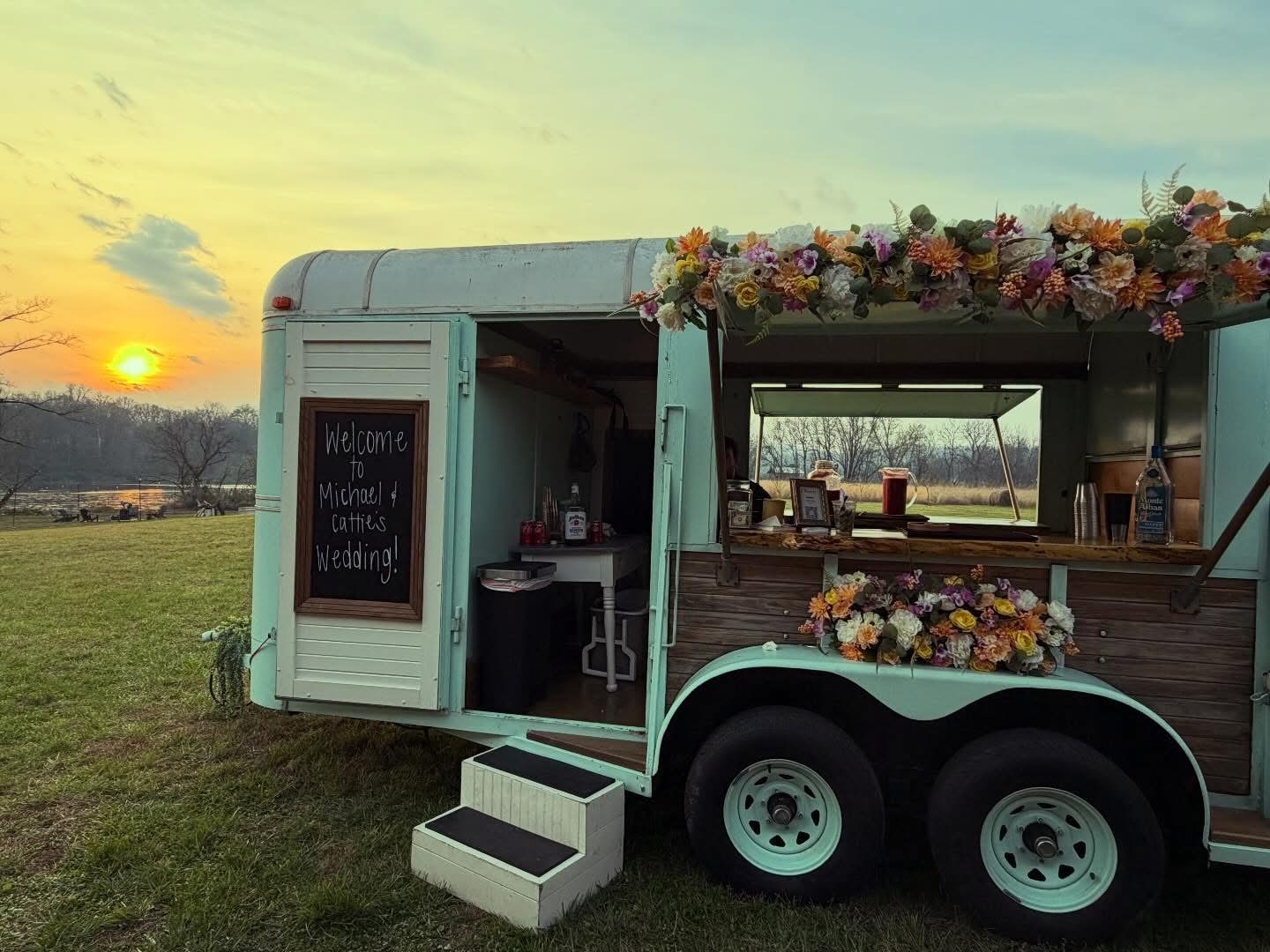 The mobile bar at golden hour with a wedding welcome chalkboard