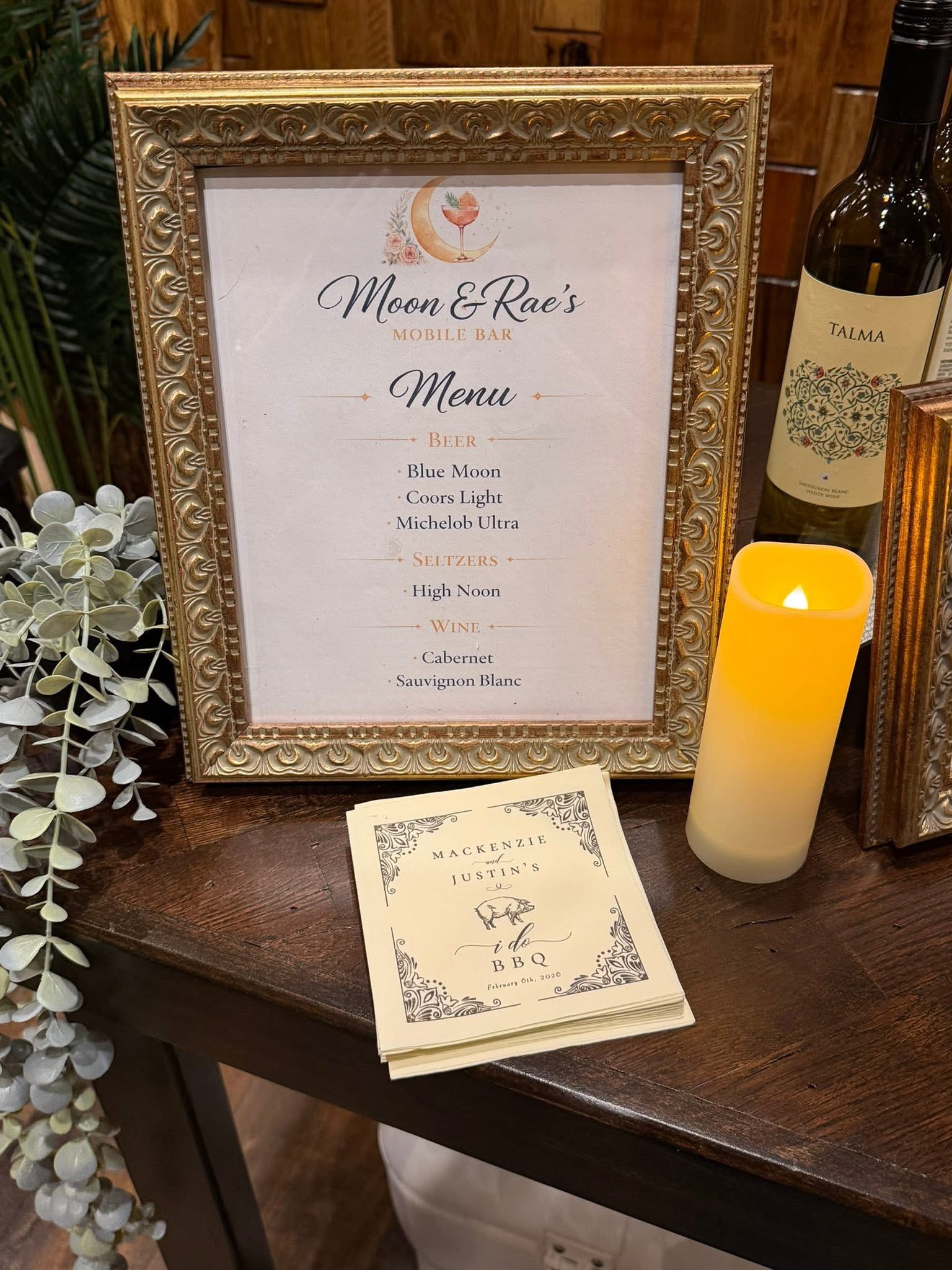 Framed Moon & Rae's drink menu at a reception