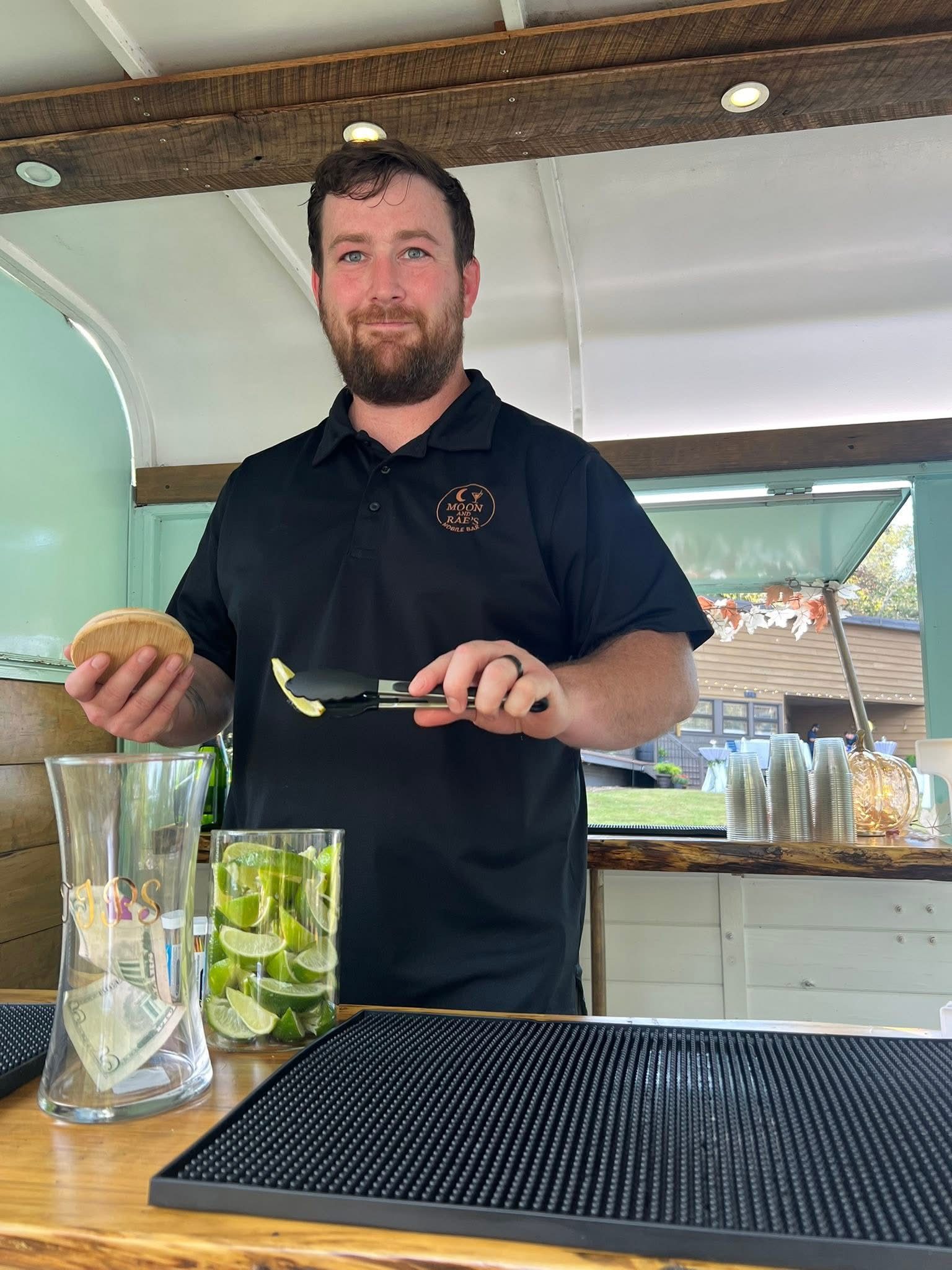 Colin, co-owner of Moon & Rae's and a U.S. veteran, behind the bar